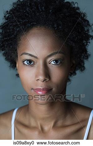 Stock Image - Portrait of woman with afro hair. Fotosearch