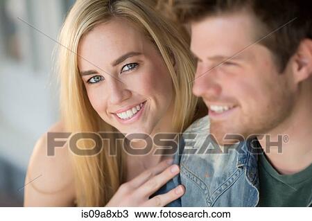 Stock Image - Portrait of young couple smiling. Fotosearch