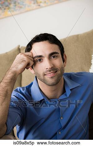 Portrait of young man leaning on elbow View Large Photo Image Stock Photography - Portrait of young man leaning on elbow. Fotosearch