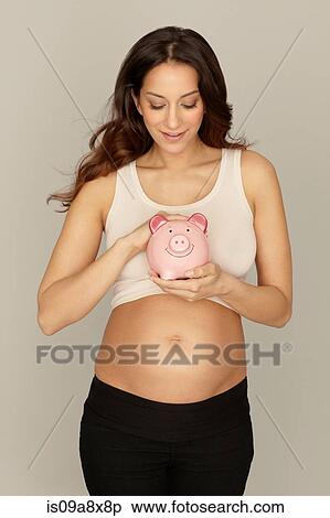 Pregnant woman holding piggy bank View Large Photo Image Stock Photography - Pregnant woman holding piggy bank. Fotosearch
