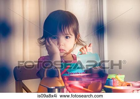 Sad girl playing with toys View Large Photo Image Stock Image - Sad girl playing with toys. Fotosearch