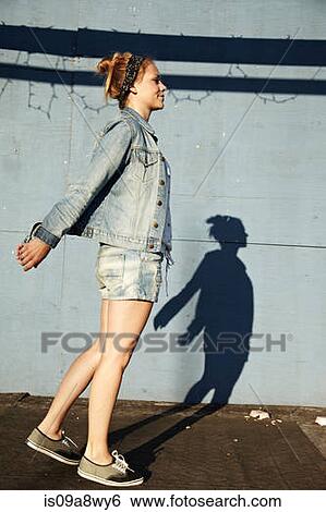 Side view of woman and shadow View Large Photo Image Stock Photograph - Side view of woman and shadow. Fotosearch