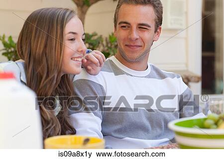 Stock Photo - Sister and brother smiling, portrait. Fotosearch