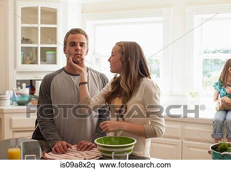 Stock Photography - Sister squeezing brother's cheeks. Fotosearch