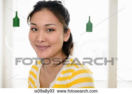 Stock Image - Smiling woman looking at camera. Fotosearch