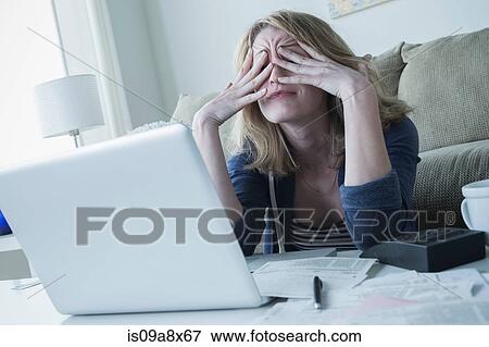 Stressed young woman rubbing eyes View Large Photo Image Stock Photo - Stressed young woman rubbing eyes. Fotosearch
