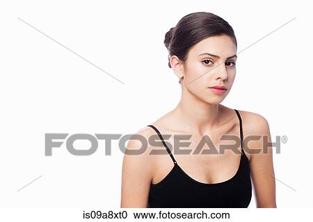 Stock Image - Studio portrait of young woman wearing black vest. Fotosearch