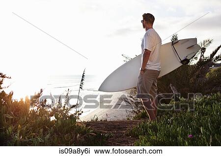 Surfer looking at ocean View Large Photo Image Stock Image - Surfer looking at ocean. Fotosearch