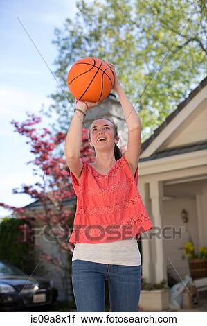 Teenage girl holding basketball above head View Large Photo Image Stock Image - Teenage girl holding basketball above head. Fotosearch