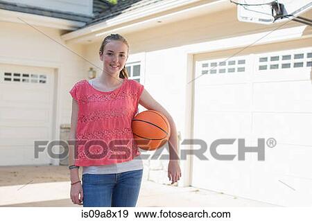 Stock Photo - Teenage girl holding basketball, portrait. Fotosearch