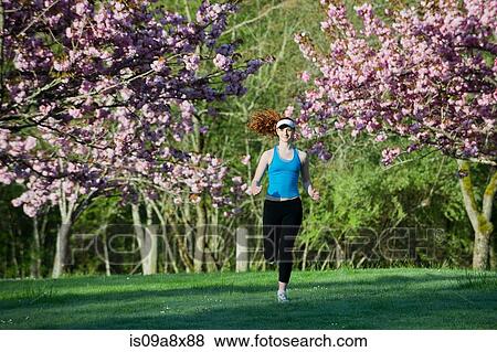 Teenage girl jogging in park View Large Photo Image Stock Photo - Teenage girl jogging in park. Fotosearch