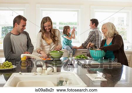 Three generation family in kitchen preparing food View Large Photo Image Stock Photography - Three generation family in kitchen preparing food. Fotosearch