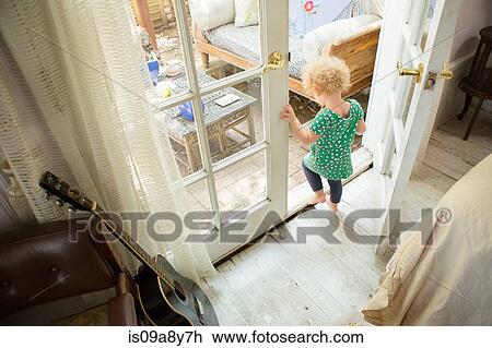Stock Image - Toddler going onto verandah. Fotosearch