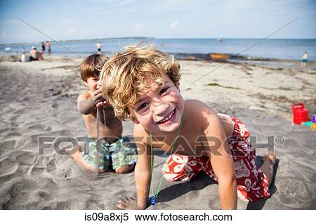 Stock Photography - Two boys playing on beach. Fotosearch