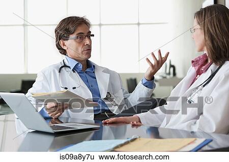 Stock Photograph - Two doctors in discussion. Fotosearch