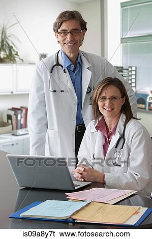 Two doctors looking at camera View Large Photo Image Stock Photograph - Two doctors looking at camera. Fotosearch