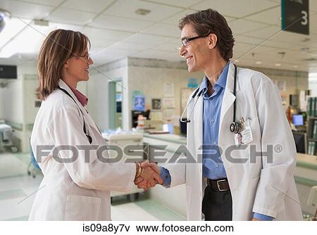 Two doctors shaking hands View Large Photo Image Stock Photo - Two doctors shaking hands. Fotosearch