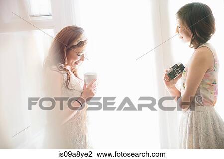 Stock Image - Two happy women chatting. Fotosearch