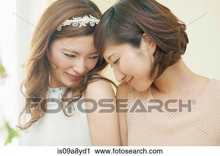 Two women nuzzling foreheads View Large Photo Image Stock Image - Two women nuzzling foreheads. Fotosearch