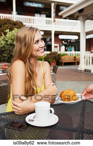 Stock Image - Woman being served croissant. Fotosearch