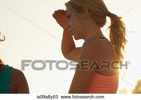 Woman blocking sun with hand View Large Photo Image Stock Image - Woman blocking sun with hand. Fotosearch