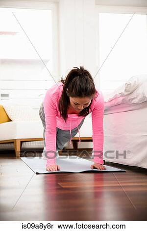 Stock Photography - Woman doing push ups. Fotosearch