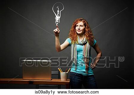 Woman drawing a light bulb View Large Photo Image Stock Photo - Woman drawing a light bulb. Fotosearch