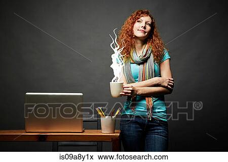 Stock Photo - Woman enjoying cup of steaming hot beverage. Fotosearch