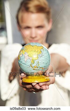 Stock Image - Woman holding globe. Fotosearch