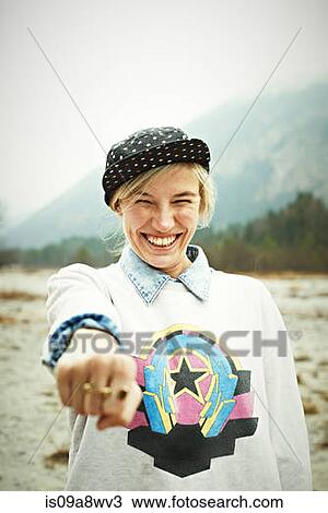 Woman holding hand out and smiling View Large Photo Image Stock Image - Woman holding hand out and smiling. Fotosearch