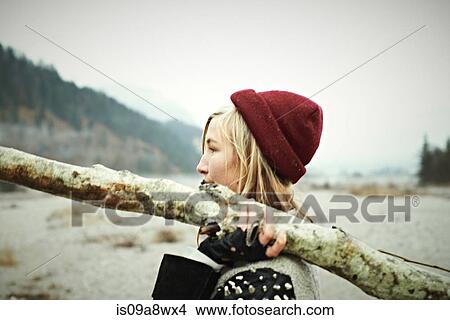 Picture - Woman holding log. Fotosearch