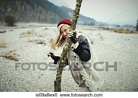 Woman holding log View Large Photo Image Stock Image - Woman holding log. Fotosearch