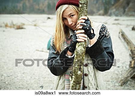 Stock Image - Woman holding log. Fotosearch