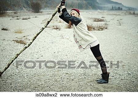 Stock Image - Woman holding log. Fotosearch