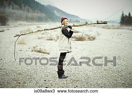 Woman holding log View Large Photo Image Stock Image - Woman holding log. Fotosearch