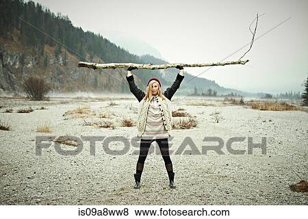 Stock Photo - Woman holding log. Fotosearch
