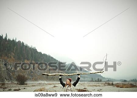 Woman holding log View Large Photo Image Stock Photo - Woman holding log. Fotosearch