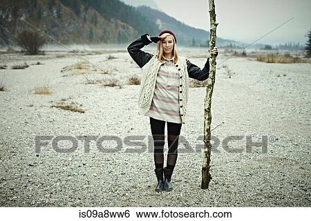 Stock Photograph - Woman holding log. Fotosearch
