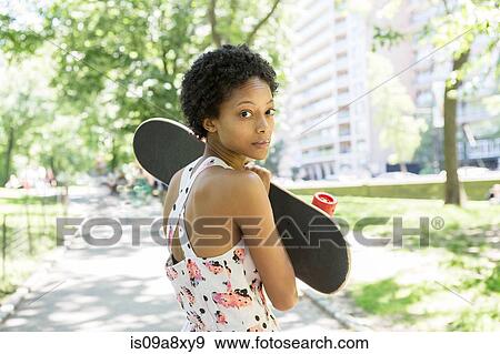 Woman hugging skateboard View Large Photo Image Stock Photo - Woman hugging skateboard. Fotosearch