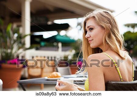 Woman in outdoor café relaxing View Large Photo Image Stock Image - Woman in outdoor café relaxing. Fotosearch