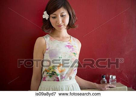 Woman leaning against red wall View Large Photo Image Stock Photo - Woman leaning against red wall. Fotosearch
