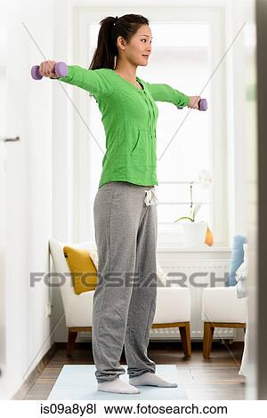 Woman lifting dumbbells with both arms View Large Photo Image Stock Image - Woman lifting dumbbells with both arms. Fotosearch