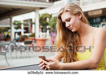 Woman looking at mobile phone View Large Photo Image Stock Photo - Woman looking at mobile phone. Fotosearch