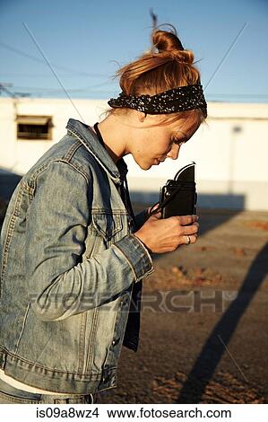 Picture - Woman looking at vintage camera. Fotosearch