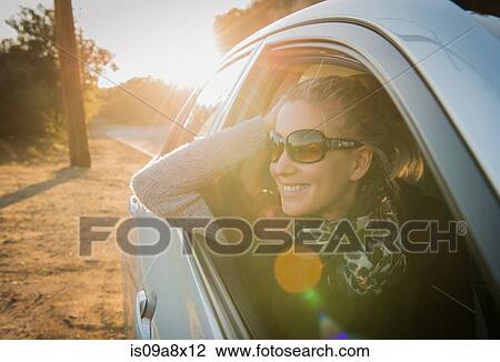 Woman looking out of car window View Large Photo Image Stock Image - Woman looking out of car window. Fotosearch