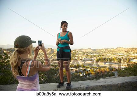 Woman photographing friend View Large Photo Image Stock Image - Woman photographing friend. Fotosearch