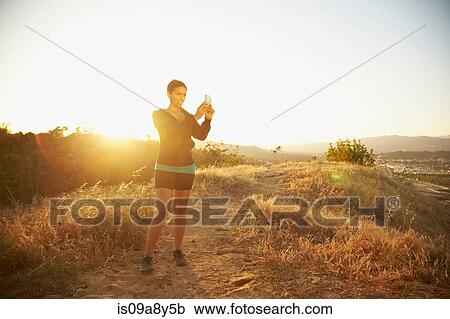 Woman photographing scenery View Large Photo Image Stock Image - Woman photographing scenery. Fotosearch