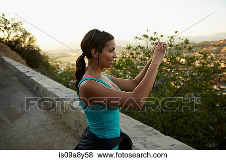 Stock Photo - Woman photographing scenery. Fotosearch