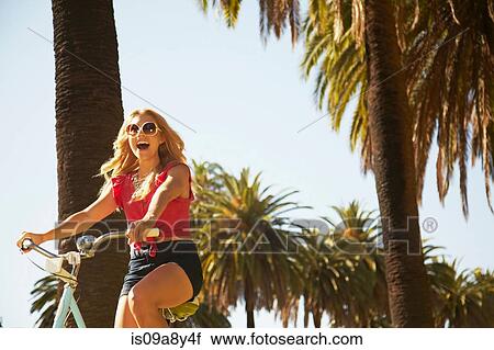 Woman riding bicycle View Large Photo Image Stock Image - Woman riding bicycle. Fotosearch