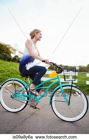Stock Image - Woman riding bicycle. Fotosearch